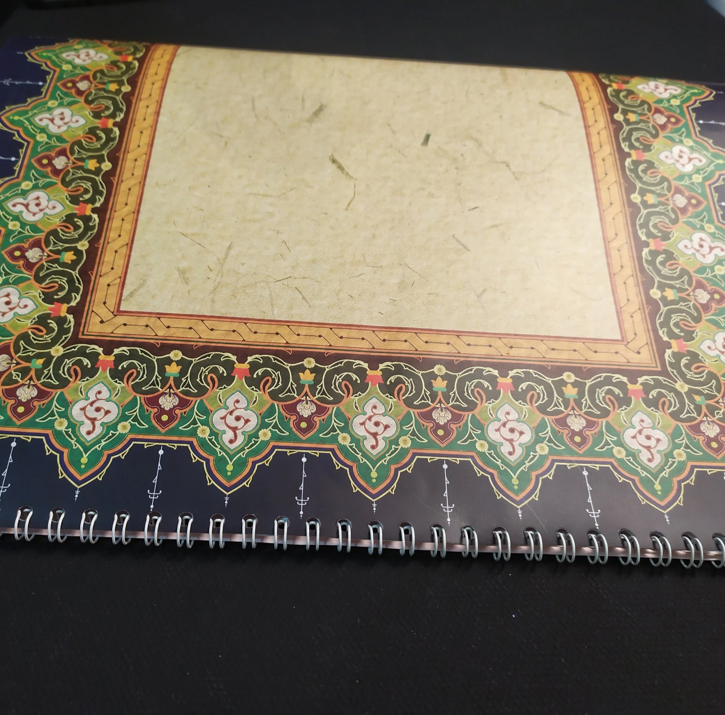 Calligraphy practice on glossy sheet showing ornamental edges