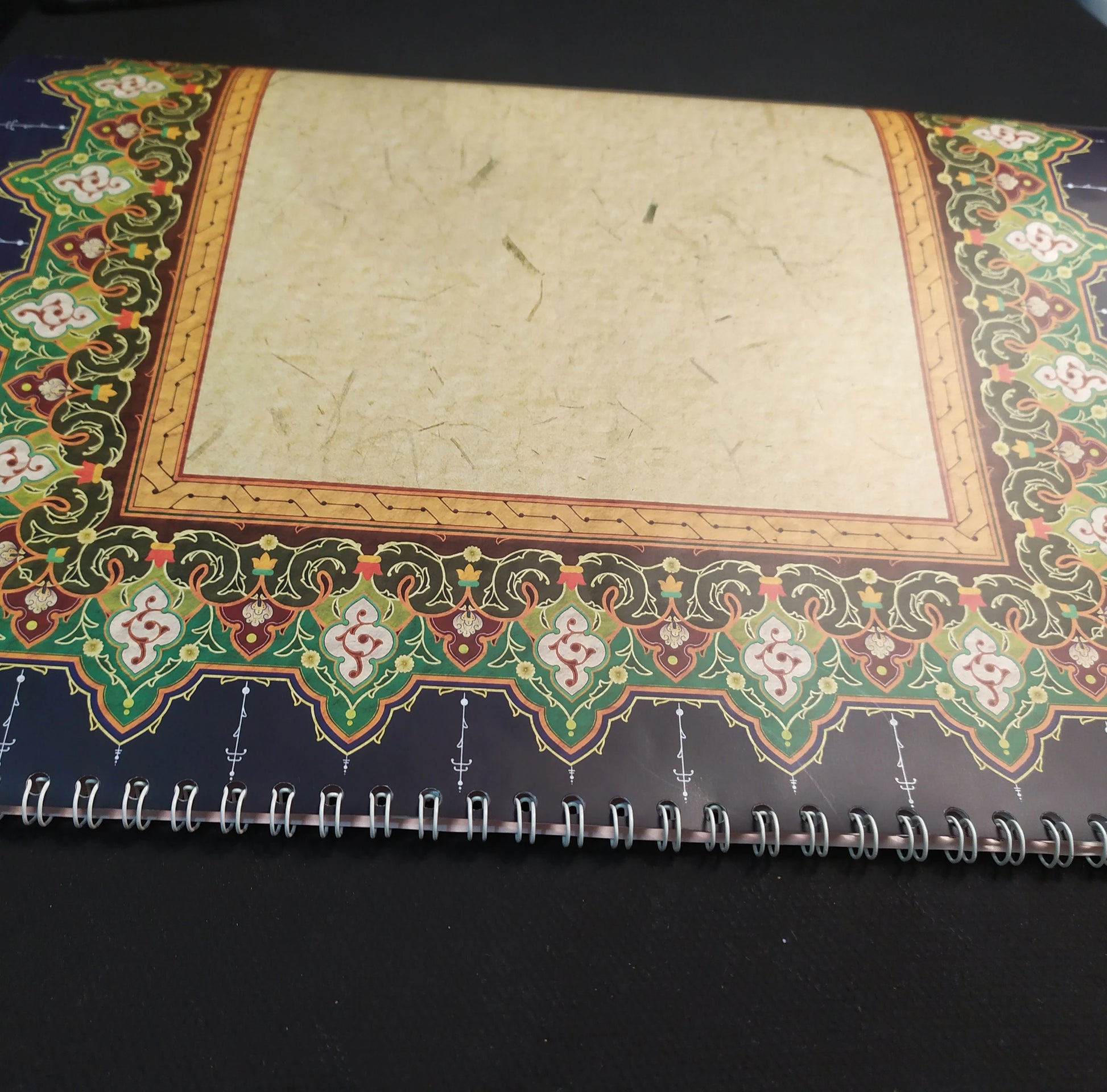 Calligraphy practice on glossy sheet showing ornamental edges